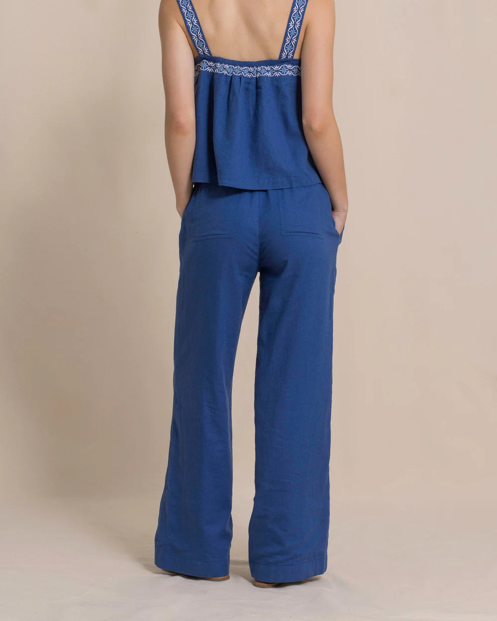 Person wearing a blue outfit with a plain background