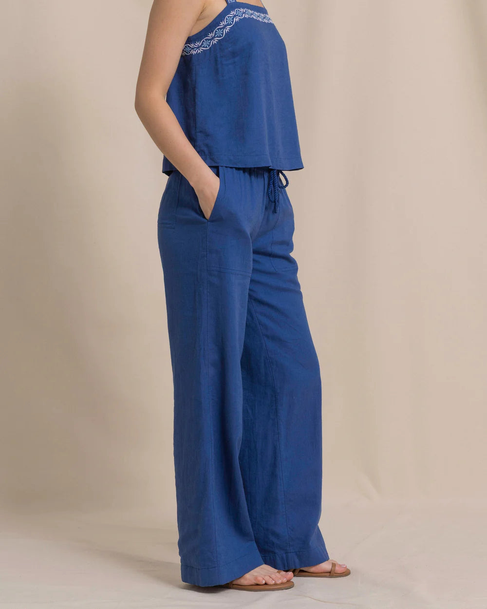 Blue outfit with a matching top and pants on a neutral background